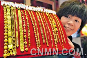 1月30日，山東聊城市一家大型商場金店的工作人員在展示黃金手鏈。