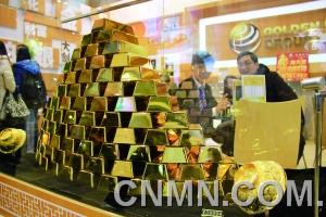 參展的金行在現(xiàn)場(chǎng)展臺(tái)用金磚壘出小“金字塔”，吸引了眾多投資者的目光。